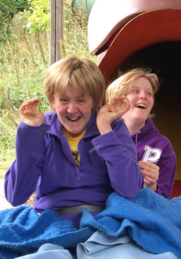 Alix and Pip enjoying a day out. The genetic change responsible for their rare disease - DDX3X - was identified by the Deciphering Developmental Disorders team who read their DNA codes (and those of their parents) and compared them with thousands of other children and parents. Photograph used with kind permission of Clare Millington